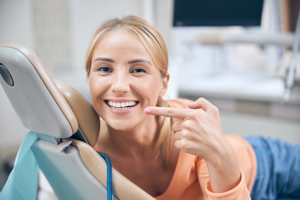Merry young woman demonstrating perfect smile at Birk Dental in Creve Coeur, MO