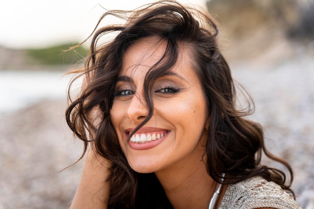 Confident woman showing off her smile after teeth whitening at Birk Dental in Creve Coeur, MO